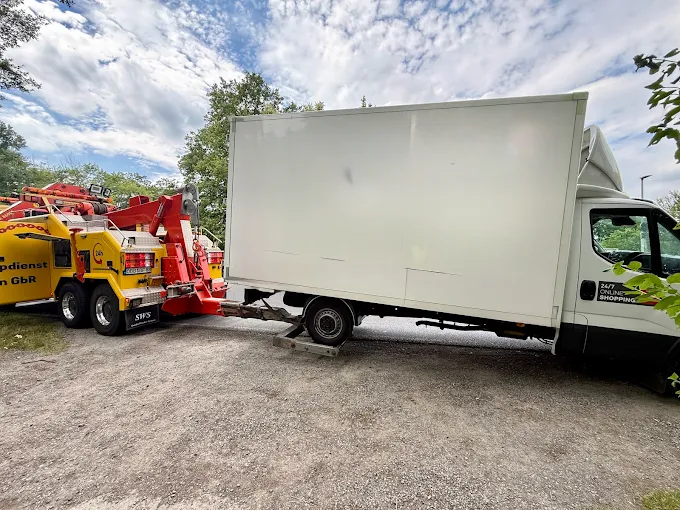 Bergefahrzeug hebt einen Koffer-Lkw zum Abschleppen an